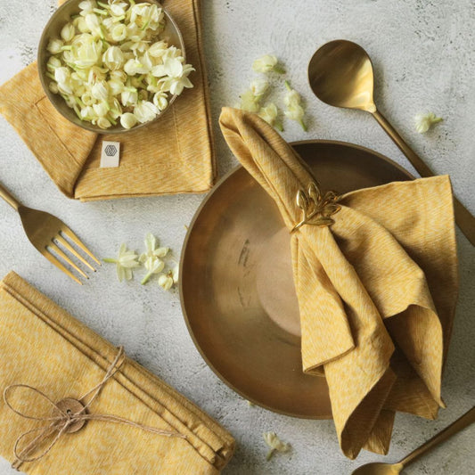 Mustard yellow cotton table napkin, fan-fold with tied center