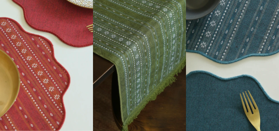 A side-by-side showcase of Bhujodi handwoven table linens, featuring red and teal scalloped placemats and a moss green table runner with traditional geometric motifs.