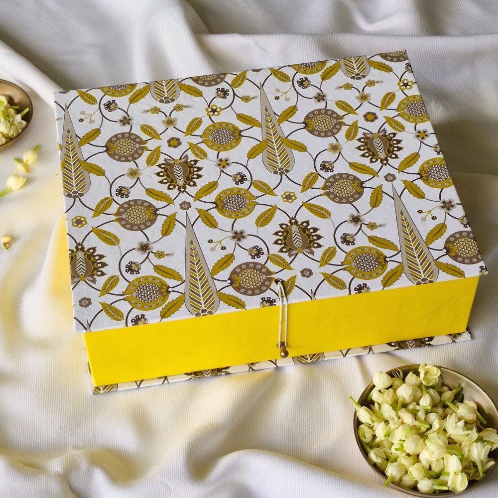 Small patterned hamper gift box with open lid flap, yellow front panel and clasp