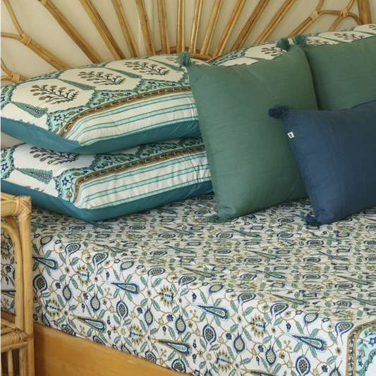 Garden Of Amalfi bedsheet with teal and blue botanical print under pillows and bedding
