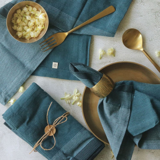 Aegean blue cotton napkins, multiple folded pieces with fabric-tie accents