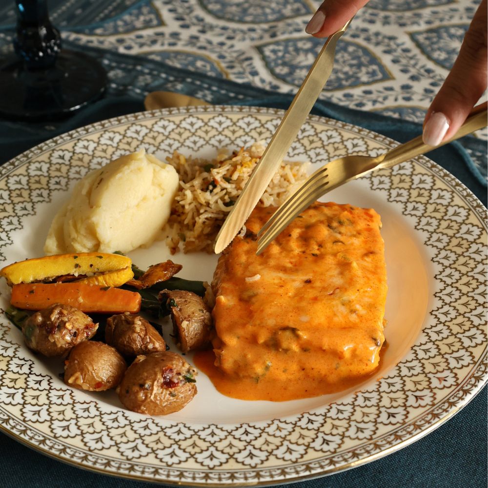 Matte gold cutlery set used with a plated meal