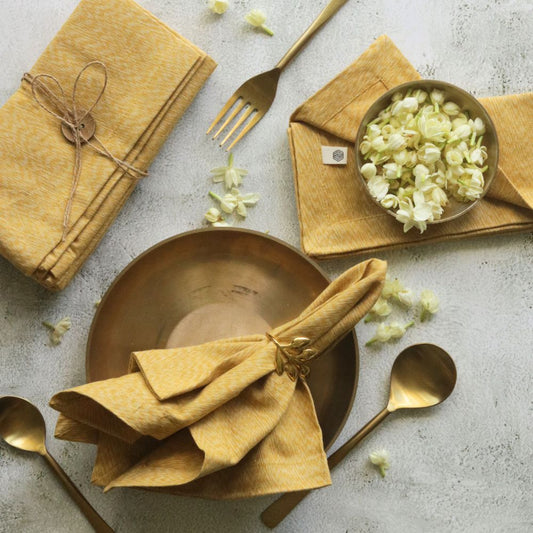 Mustard yellow cotton table napkins, folded stack with tied bow