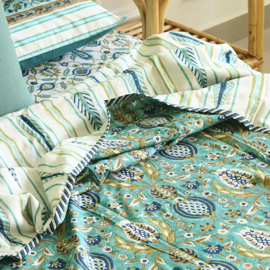 Teal and blue quilt with floral medallion print and striped border