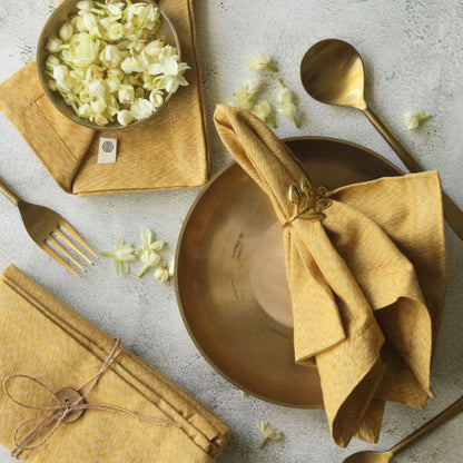 Mustard yellow cotton table napkin, fan-fold with tied center