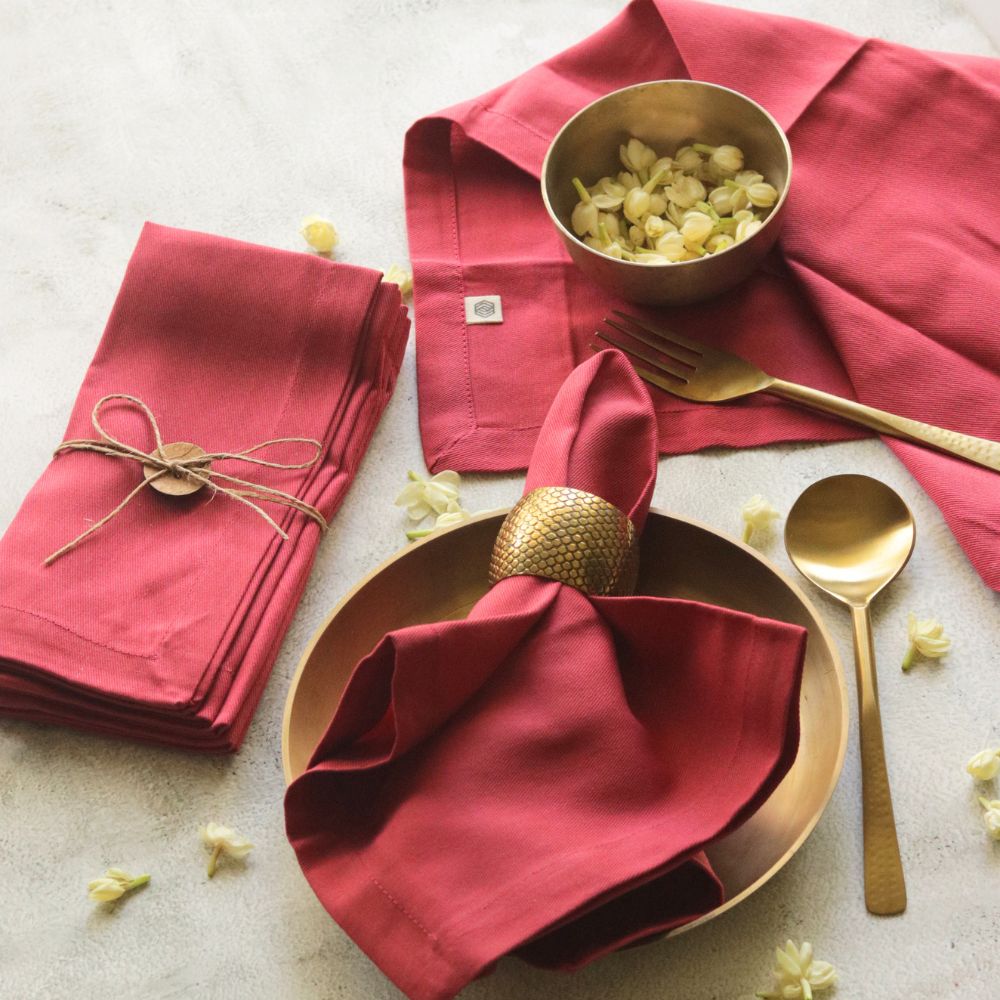Set of red cotton napkins, folded, showing neat hem and centered tag