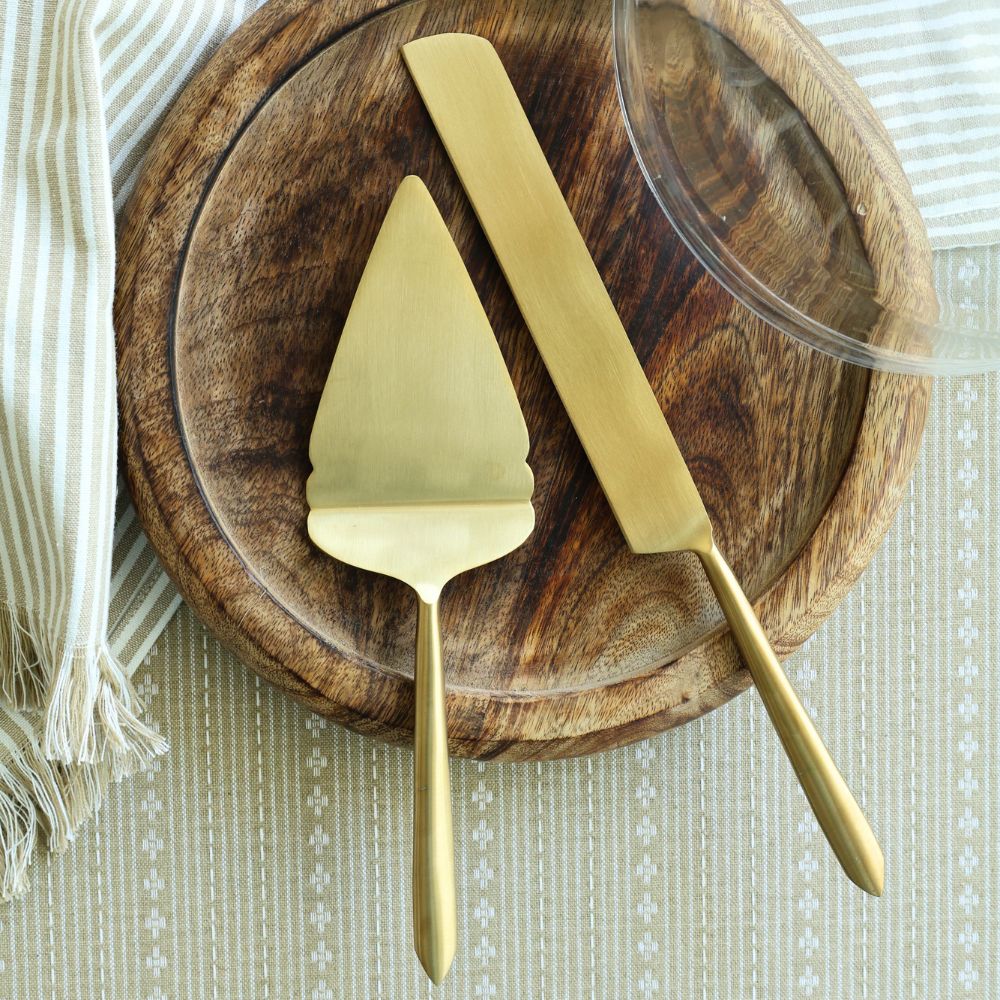 Matte gold pie cutter and server with long tapered handles.