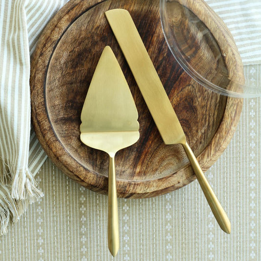 Matte gold pie cutter and server with long tapered handles.