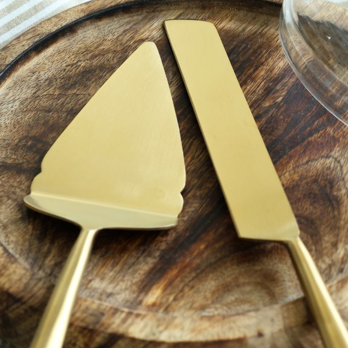 Close-up of matte gold pie cutter and server blades.