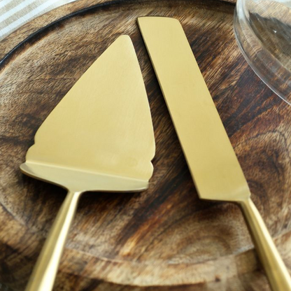 Close-up of matte gold pie cutter and server blades.