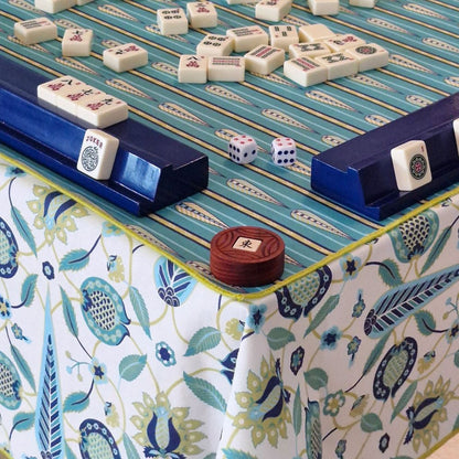 Mahjong mat with teal playing surface, blue rails, and patterned border cloth