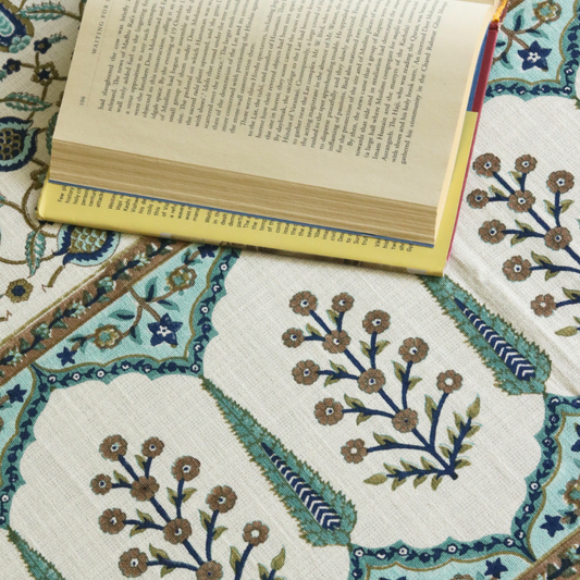 Bed cover featuring round flower medallion patches with teal trim