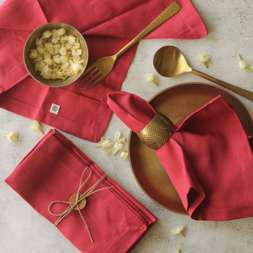 Red cotton table napkins, folded set with stitched border and tied bundle
