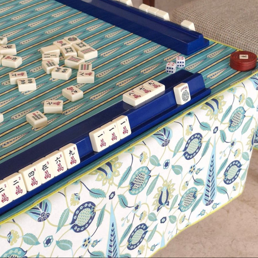 Mahjong mat with teal playing surface and dark blue rails on square patterned cloth