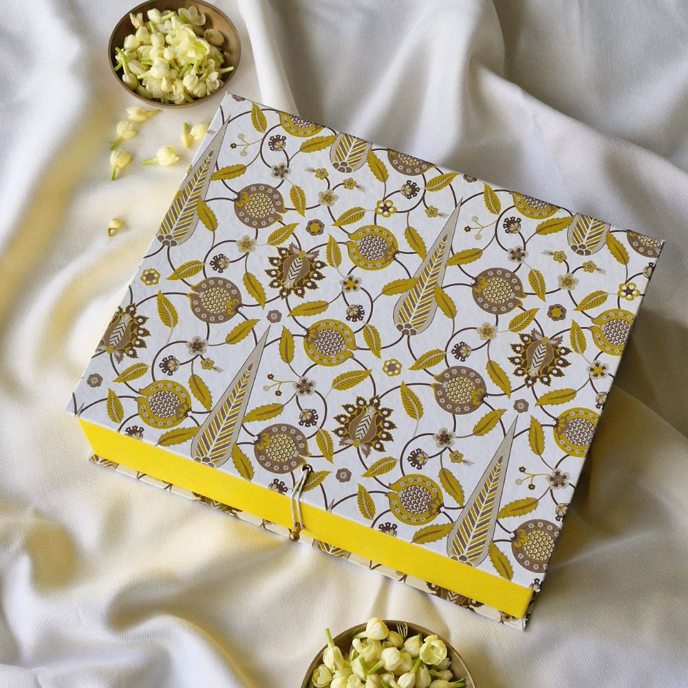 Small patterned hamper gift box with yellow base ribbon and side clasp, open lid