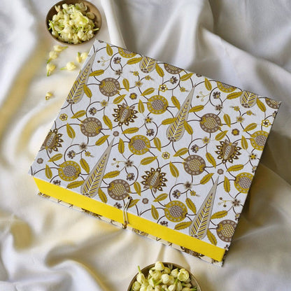 Small patterned hamper gift box with yellow base ribbon and side clasp, open lid