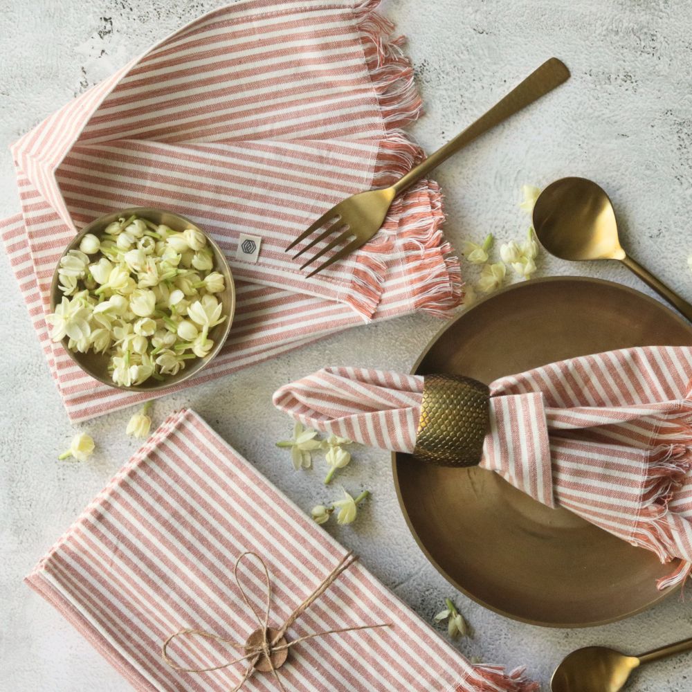 Dusty rose striped cotton table napkin set, folded with fringed edges