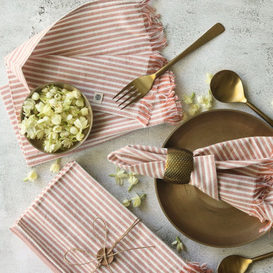 Dusty rose striped cotton table napkin set, folded with fringed edges
