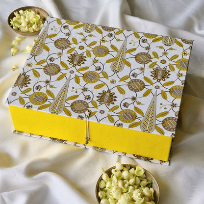 Small patterned hamper gift box with open top, yellow base and attached clasp cord