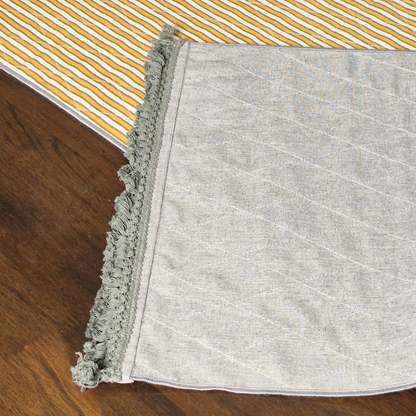 Close-up of the grey textured corner and fringed tassels on a 4 seater reversible runner.