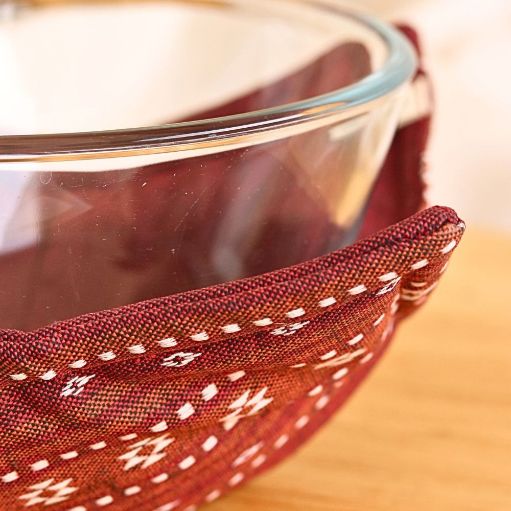 Ruby red reversible pot holder close-up of patterned fabric and stitched edge