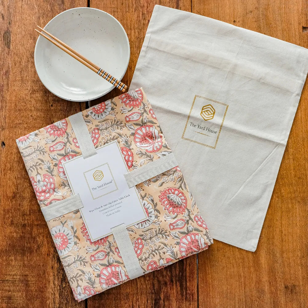 Blushing Meadows Tablecloth by The Yard House in pastel peach and pink, available in rectangle (48”x72”), square (60”x60”)...