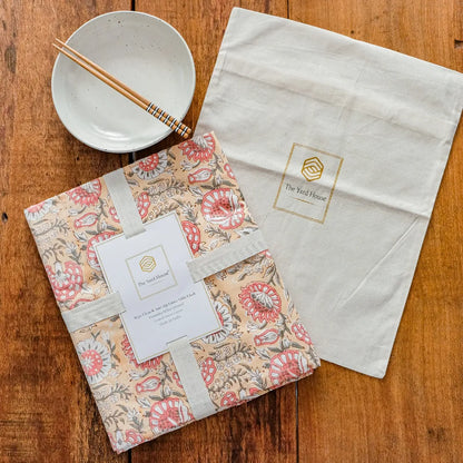 Blushing Meadows Tablecloth by The Yard House in pastel peach and pink, available in rectangle (48”x72”), square (60”x60”)...