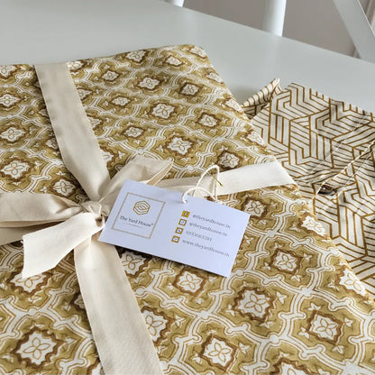 Chai & Toast Tablecloth by The Yard House in beige and brown, featuring geometric patterns, available in 4-seater round, s...
