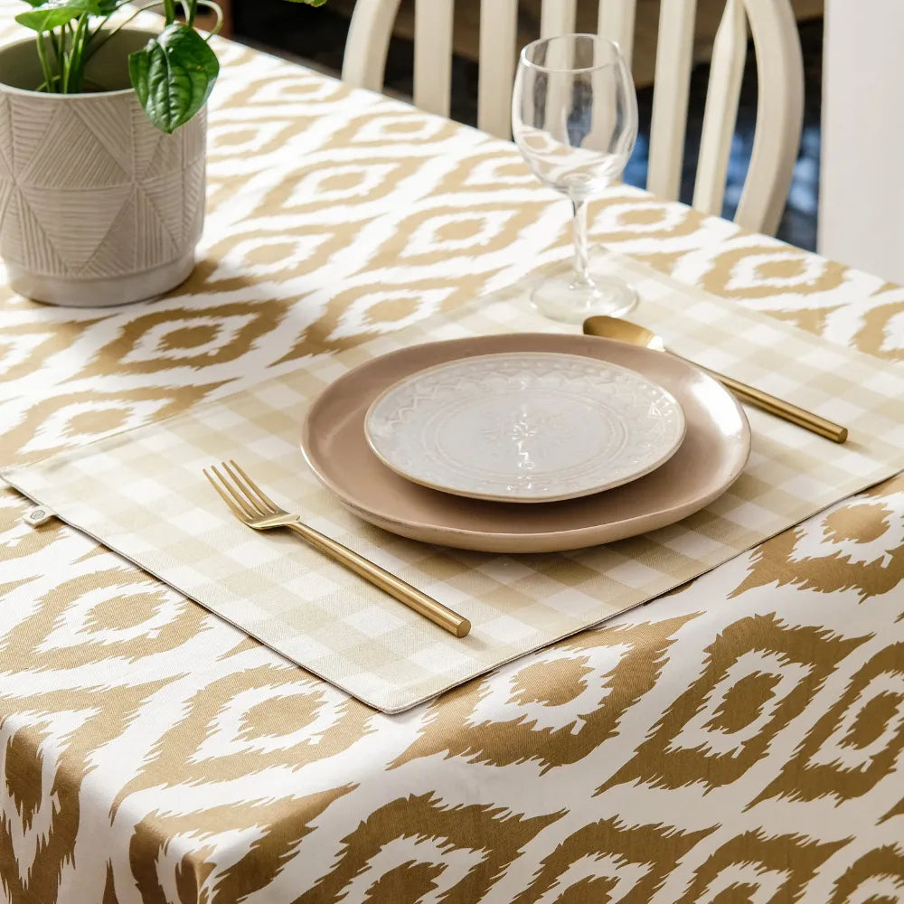 Ikat Inspired Beige Tablecloth by The Yard House, featuring abstract geometric patterns, available in 60” round or square ...