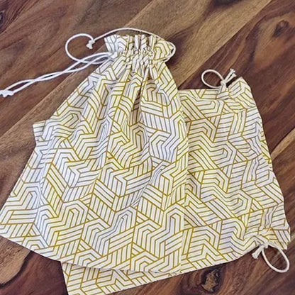 Elegant 10"x10" drawstring gift pouch by The Yard House in signature print, perfect for coasters and trivets, beige color.