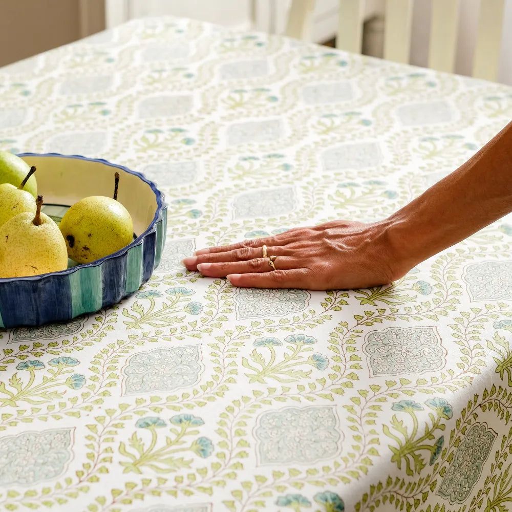 Riverside Tablecloth by The Yard House in Blue Green, 60” round, features geometric patterns and nature-inspired prints.