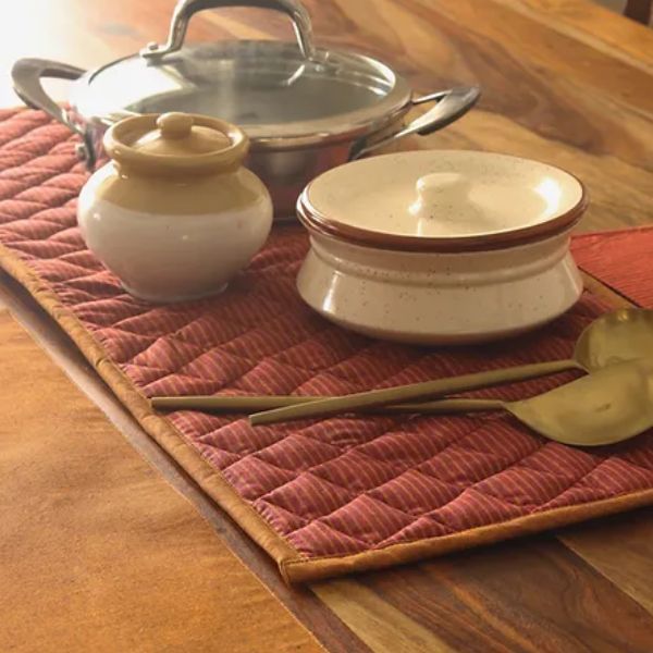 Serene Sunset Tablepad by The Yard House in red, square 15"x15", featuring a quilted design and bold geometric patterns.