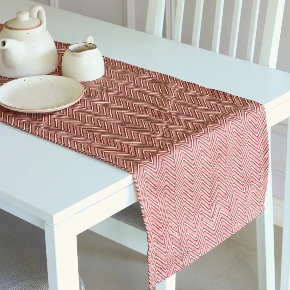 Sweet Onion (Chevron) table runner by The Yard House in bold pink, available in 4, 6, or 8-seater sizes, featuring abstrac...