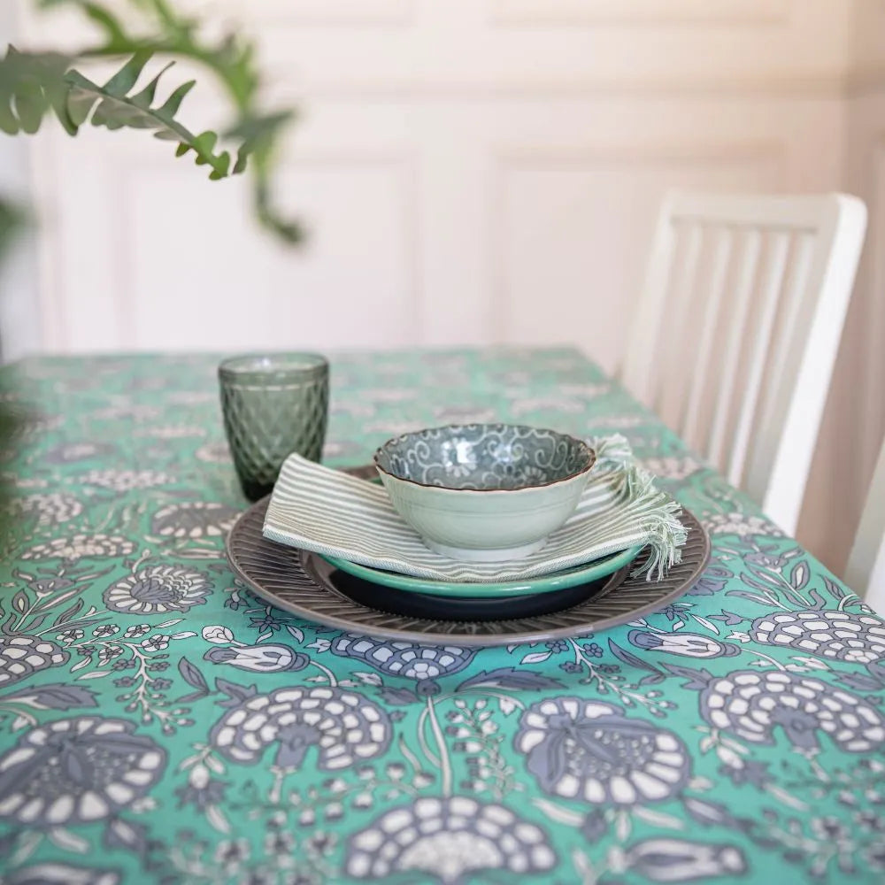 Tranquil Teal Tablecloth by The Yard House, featuring bold floral designs, available in 60” round, square, or 48”x72” rect...