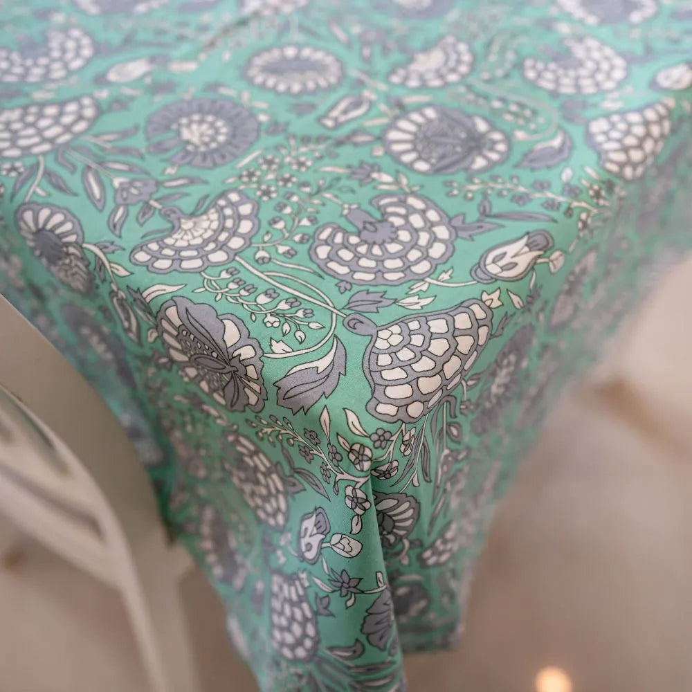 Tranquil Teal Tablecloth by The Yard House, featuring bold floral designs, available in 60” round, square, or 48”x72” rect...