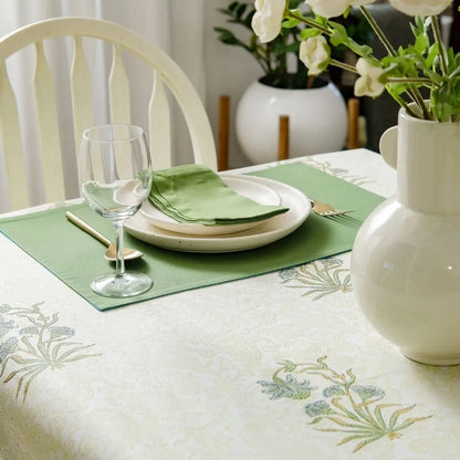 Whispering Willow Tablecloth by The Yard House in green and pale yellow, 60” square, featuring minimalist floral designs.
