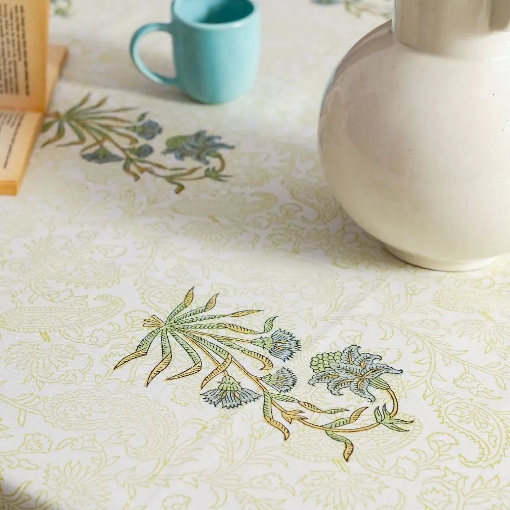 Whispering Willow Tablecloth by The Yard House in green and pale yellow, 60” square, featuring minimalist floral designs.