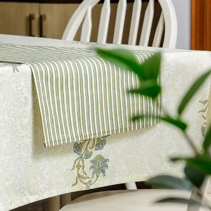 Whispering Willow Tablecloth by The Yard House in green and pale yellow, 60” square, featuring minimalist floral designs.