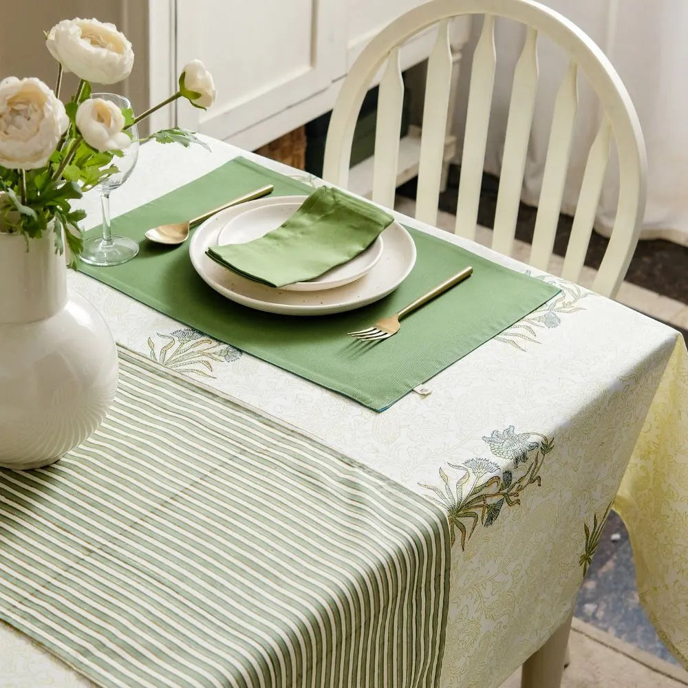 Whispering Willow Tablecloth by The Yard House in green and pale yellow, 60” square, featuring minimalist floral designs.