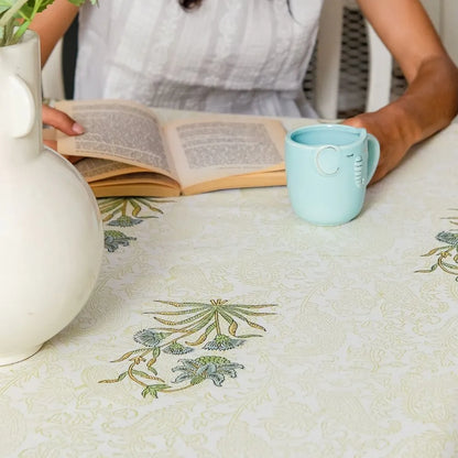 Whispering Willow Tablecloth by The Yard House in green and pale yellow, 60” square, featuring minimalist floral designs.