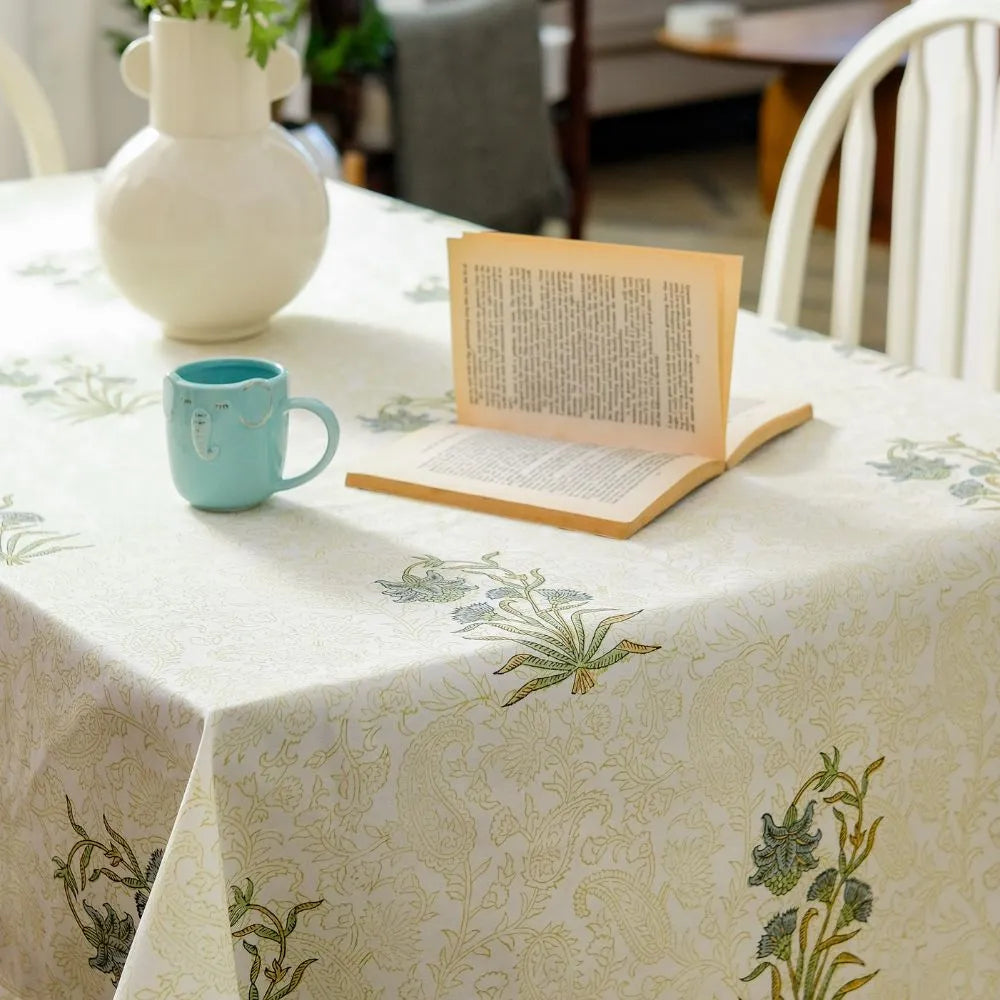 Whispering Willow Tablecloth by The Yard House in green and pale yellow, 60” square, featuring minimalist floral designs.
