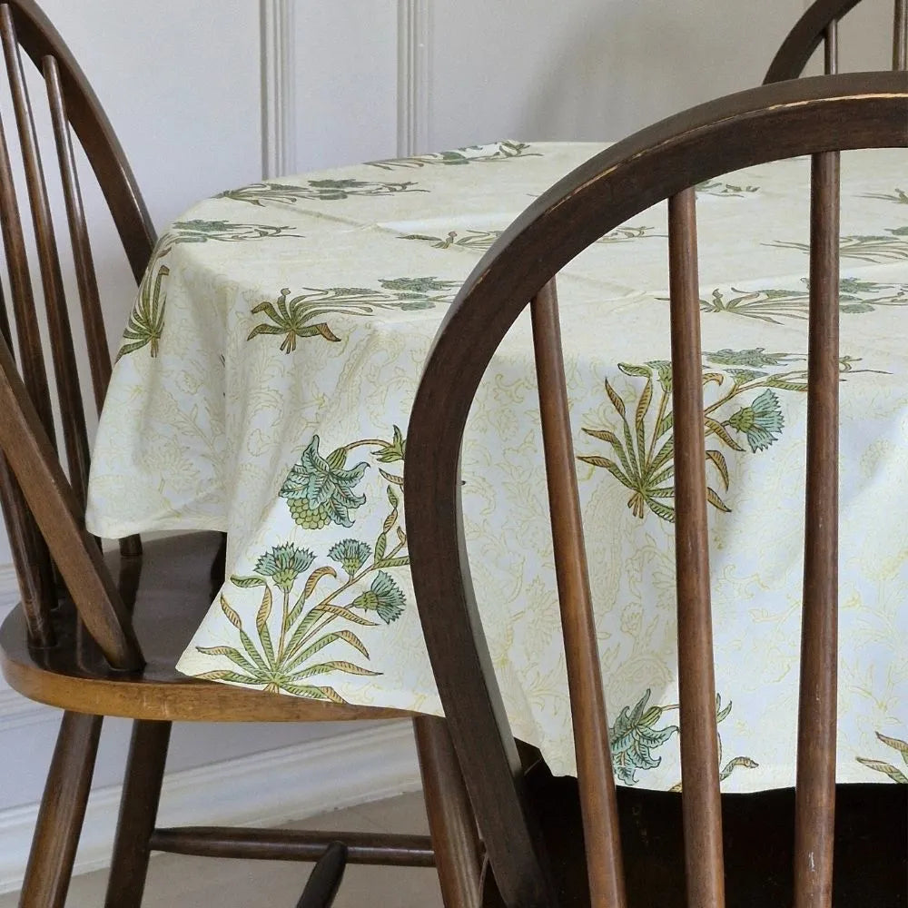 Whispering Willow Tablecloth by The Yard House in green and pale yellow, 60” square, featuring minimalist floral designs.