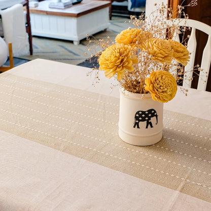 Woven Desert Sand Tablecloth by The Yard House, available in 60” square, round, or 48”x72” rectangle, featuring neutral to...