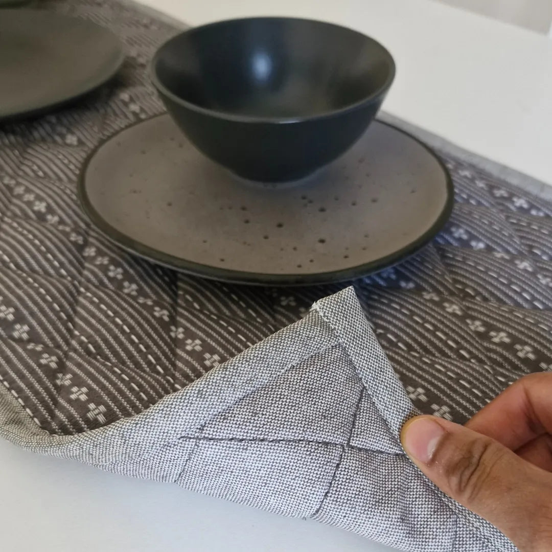 Woven Winter Grey Tablepad by The Yard House, square 15"x15", featuring geometric patterns in a minimalist monochrome pale...
