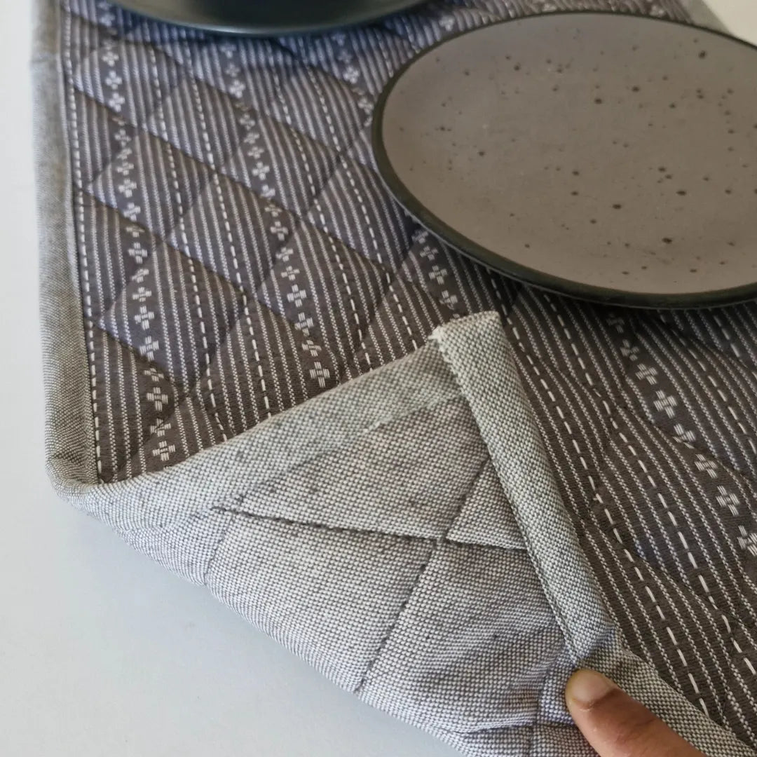 Woven Winter Grey Tablepad by The Yard House, square 15"x15", featuring geometric patterns in a minimalist monochrome pale...